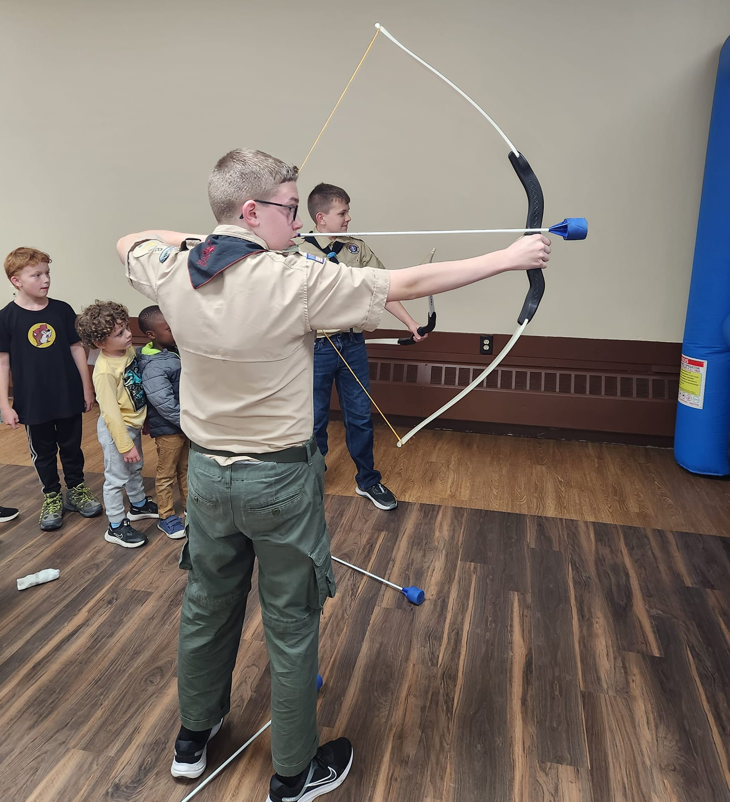 Boy Scout teaches Archery Fundamentals to future scouts.